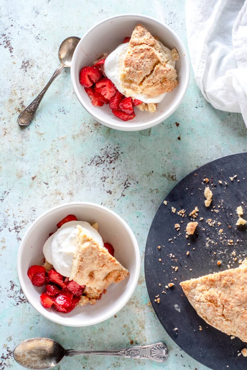 Two bowls of assembled strawberry shortcake