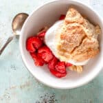 Close up of serving a strawberry shortcake with whipped cream