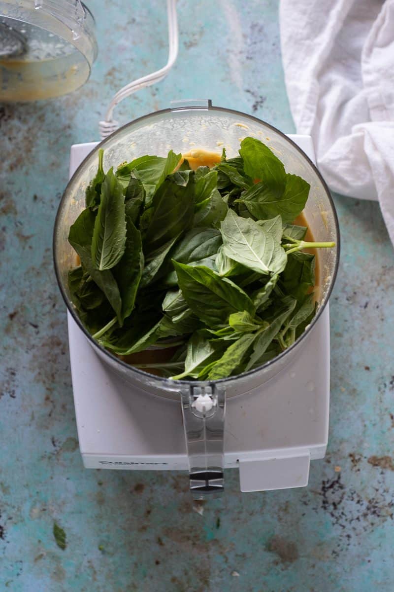 Overhead shot of basil in a food processor