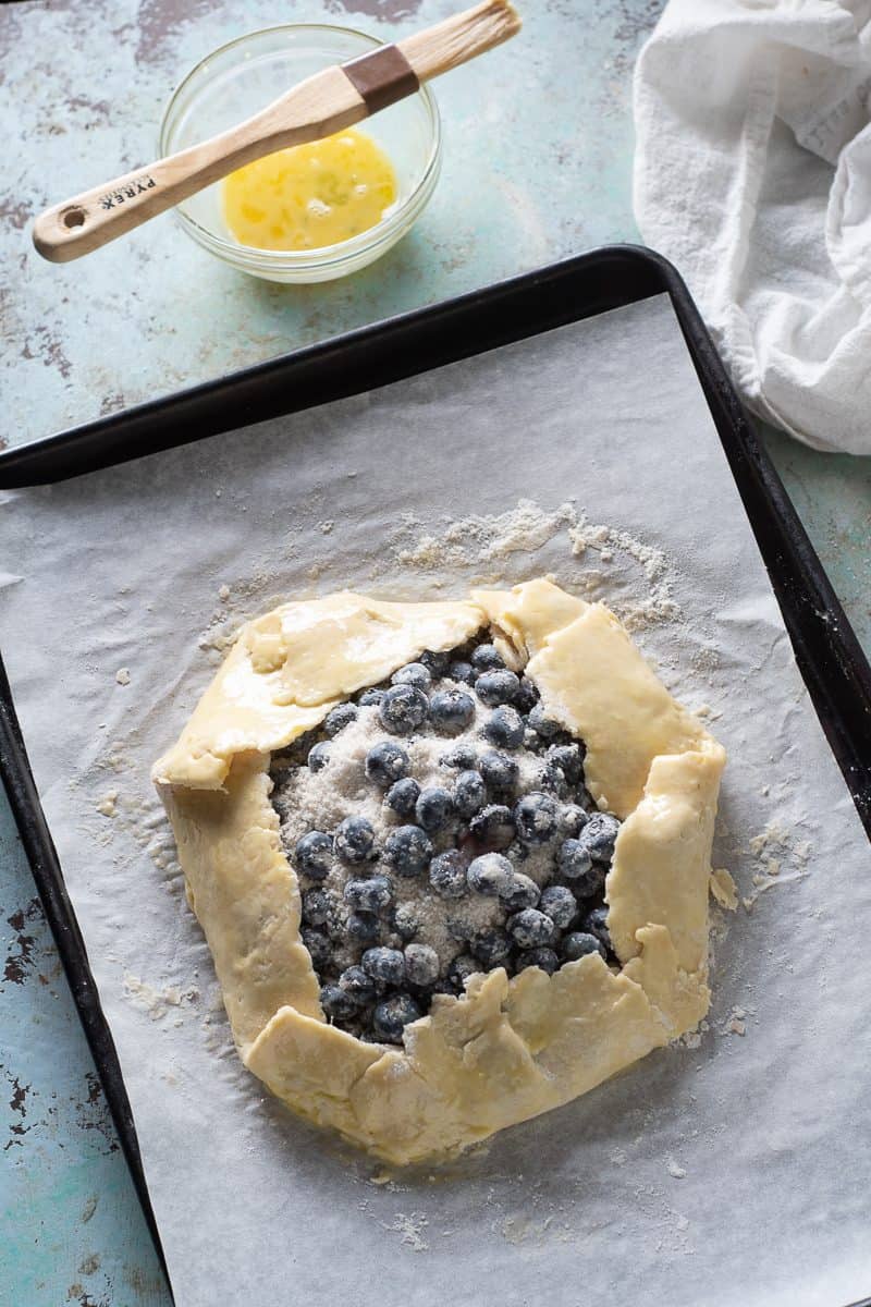 Egg wash added to blueberry galette