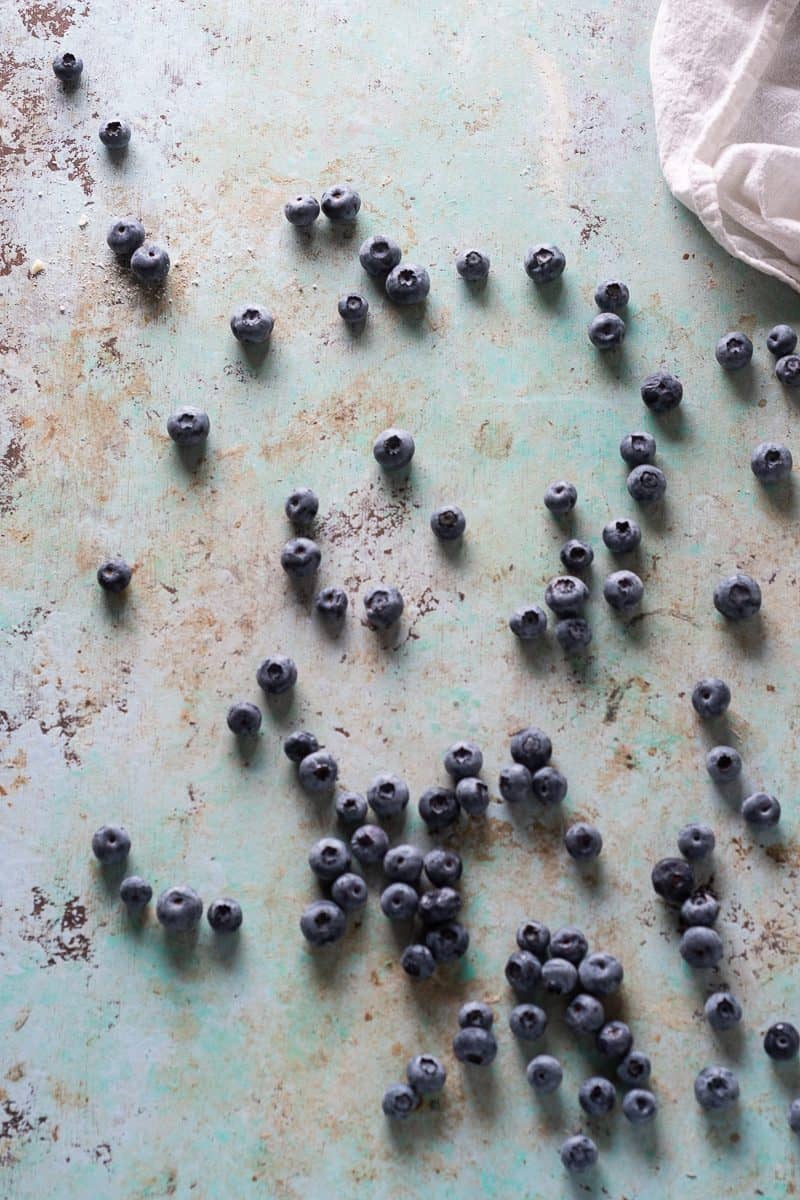 Blueberries spread out on a counter