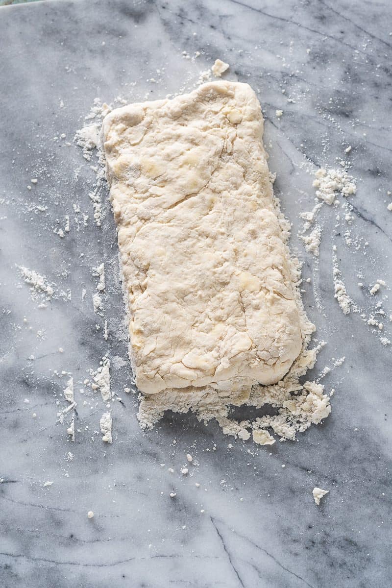 Biscuit dough patted into a rectangle