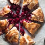 Sliced cherry galette on parchment paper