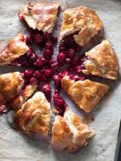 Sliced cherry galette on parchment paper