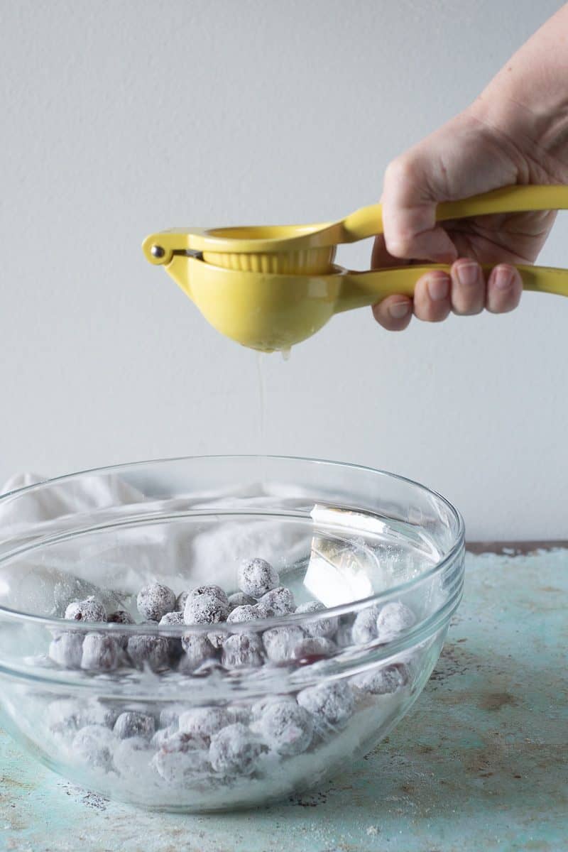 Squeezing lime juice over cherries