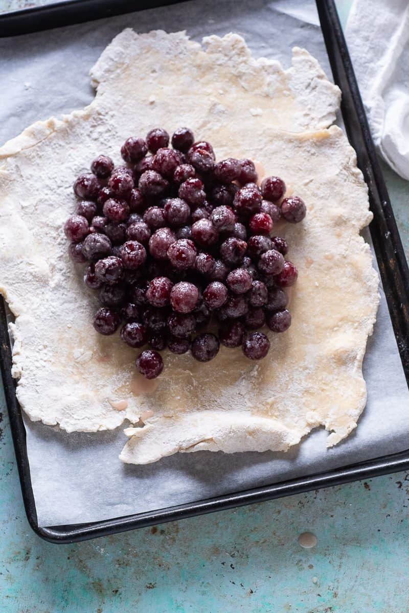 Cherries piled into center of dough