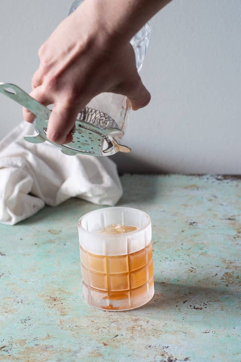 Straining the Old Fashioned into the serving glass