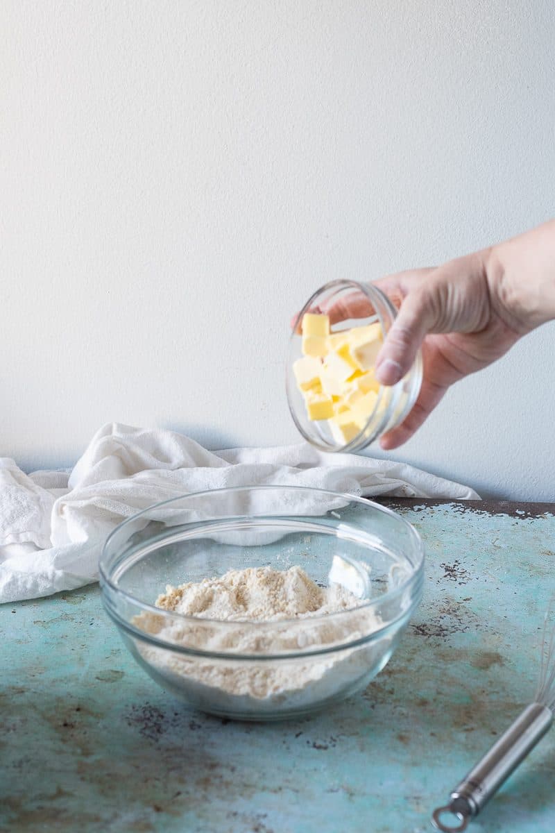 Cubes of butter added to dry ingredients