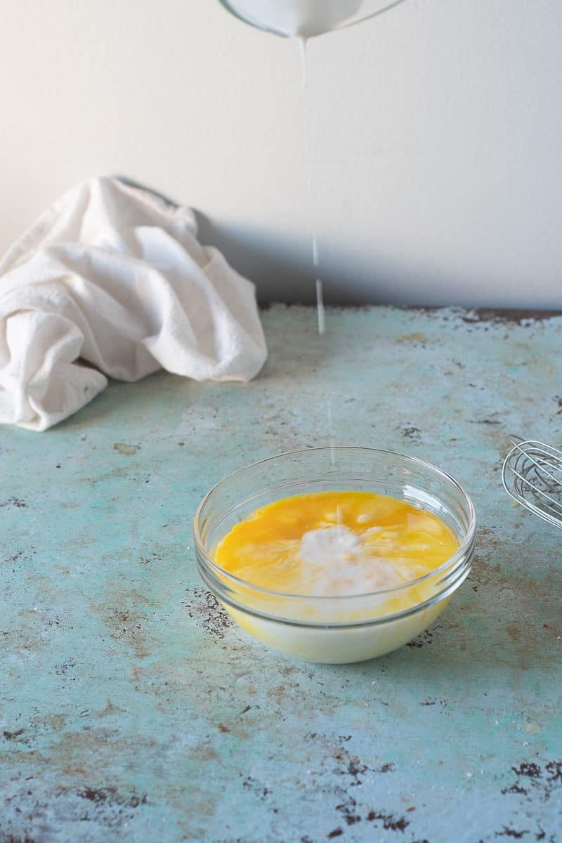 Pouring buttermilk into beaten eggs