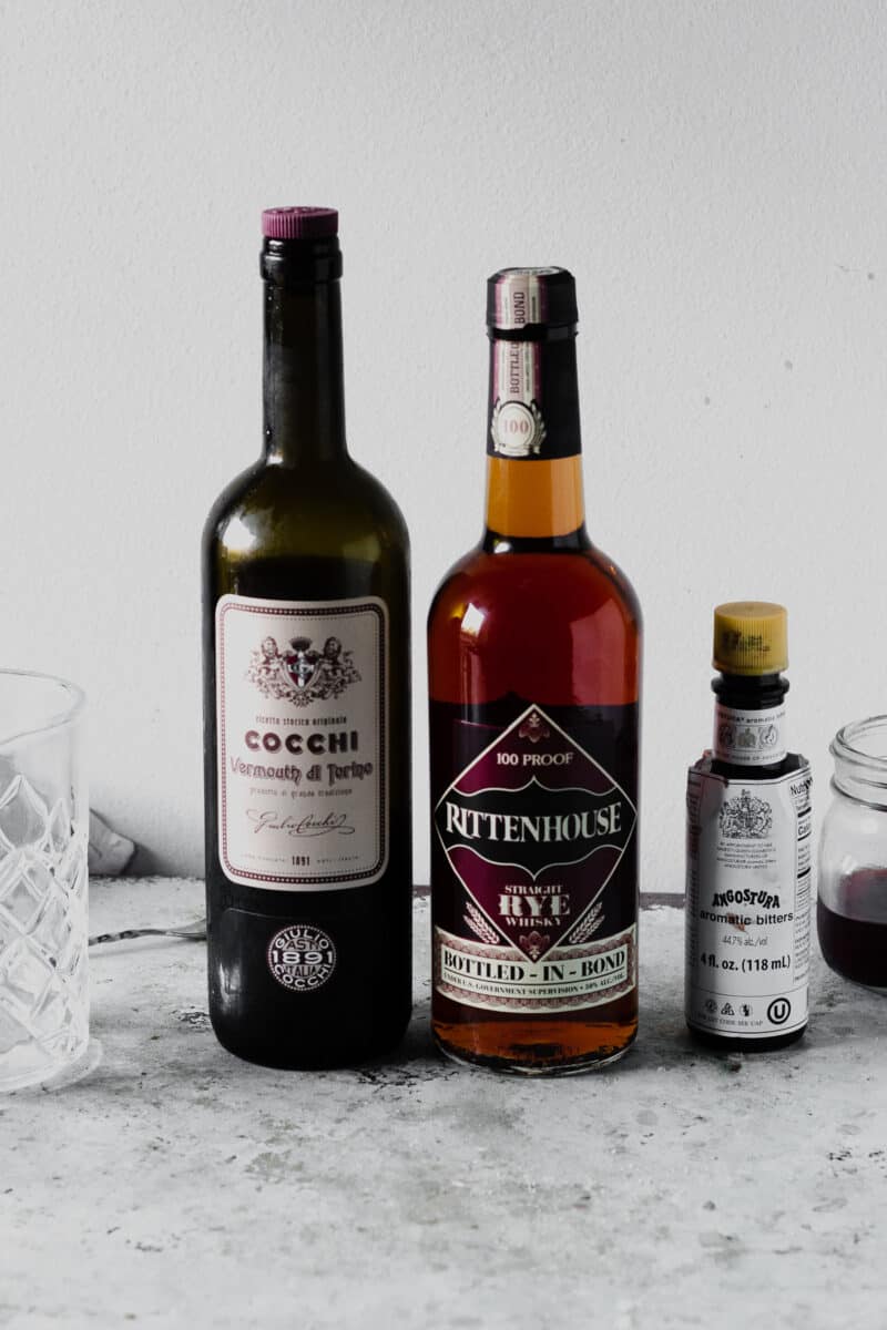 Bottles of sweet vermouth, rye, and angostura bitters