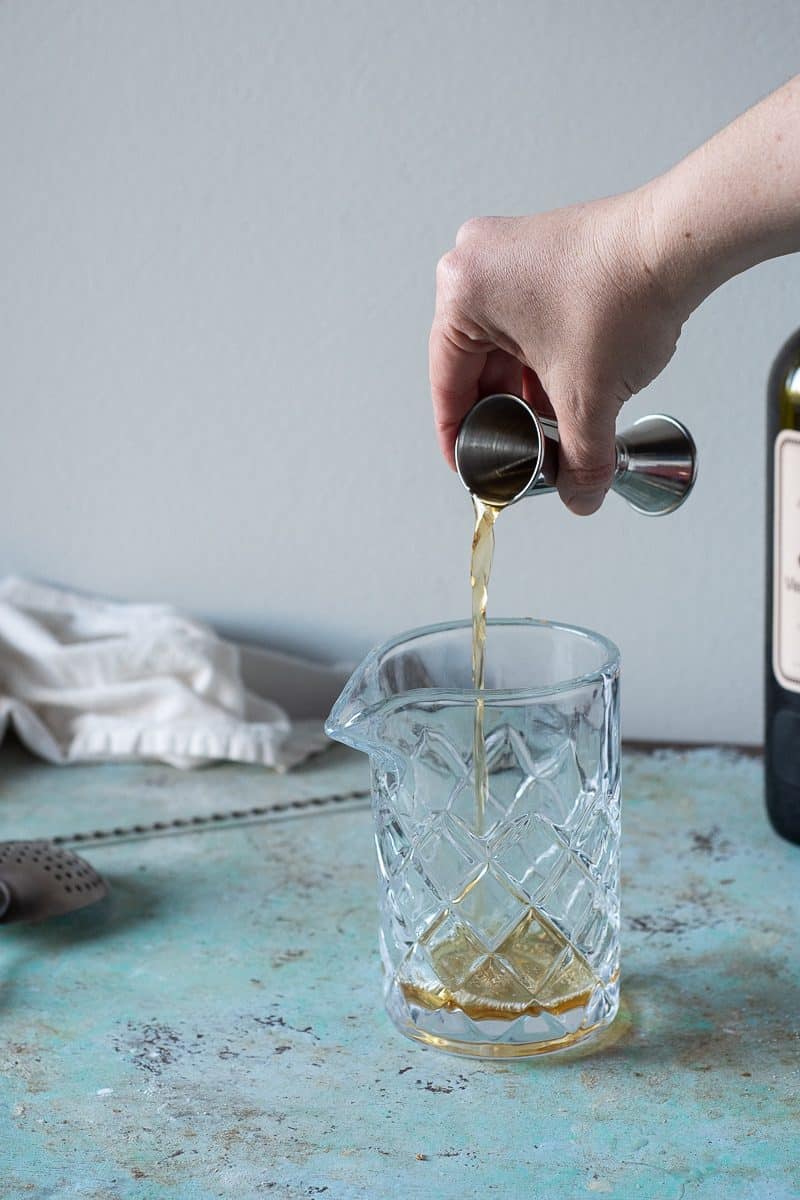 Pouring rye into a mixing glass