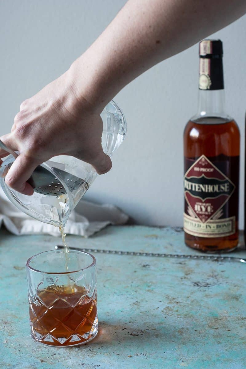 Straining a Manhattan into a cocktail glass