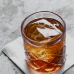 Manhattan cocktail in a rocks glass with a big ice cube