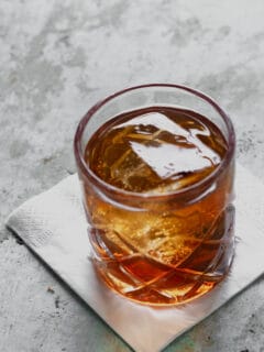 Manhattan cocktail in a rocks glass with a big ice cube