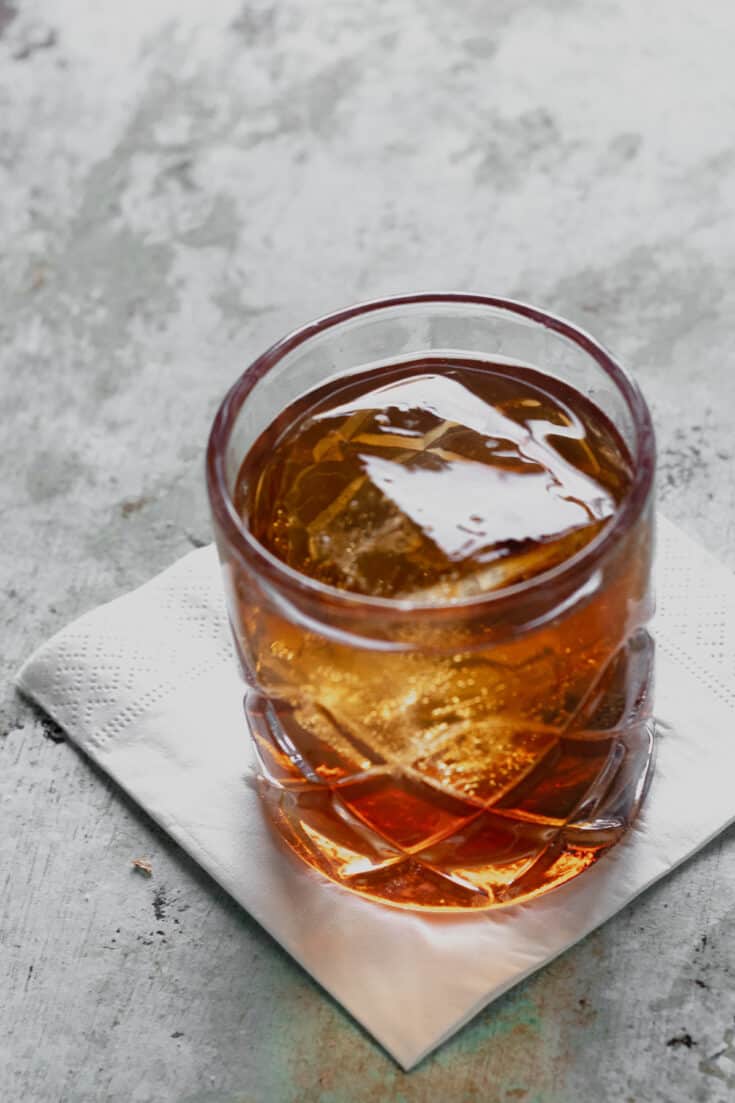 Manhattan cocktail in a rocks glass with a big ice cube