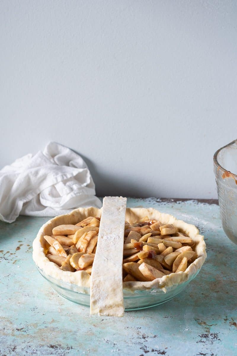 First strip of lattice laid vertically on filled pie