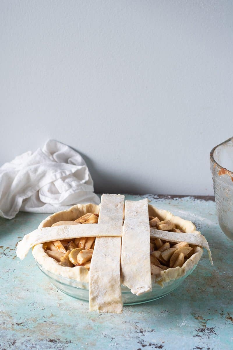 Third strip of lattice laid over the second strip and parallel to the first strip on top of the filled pie