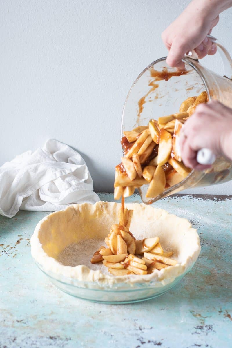 Adding the apple filling to the pie shell