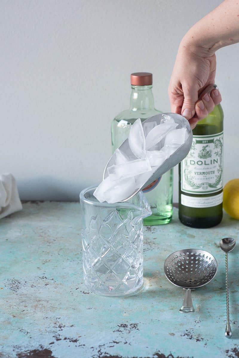 Adding ice to a mixing glass