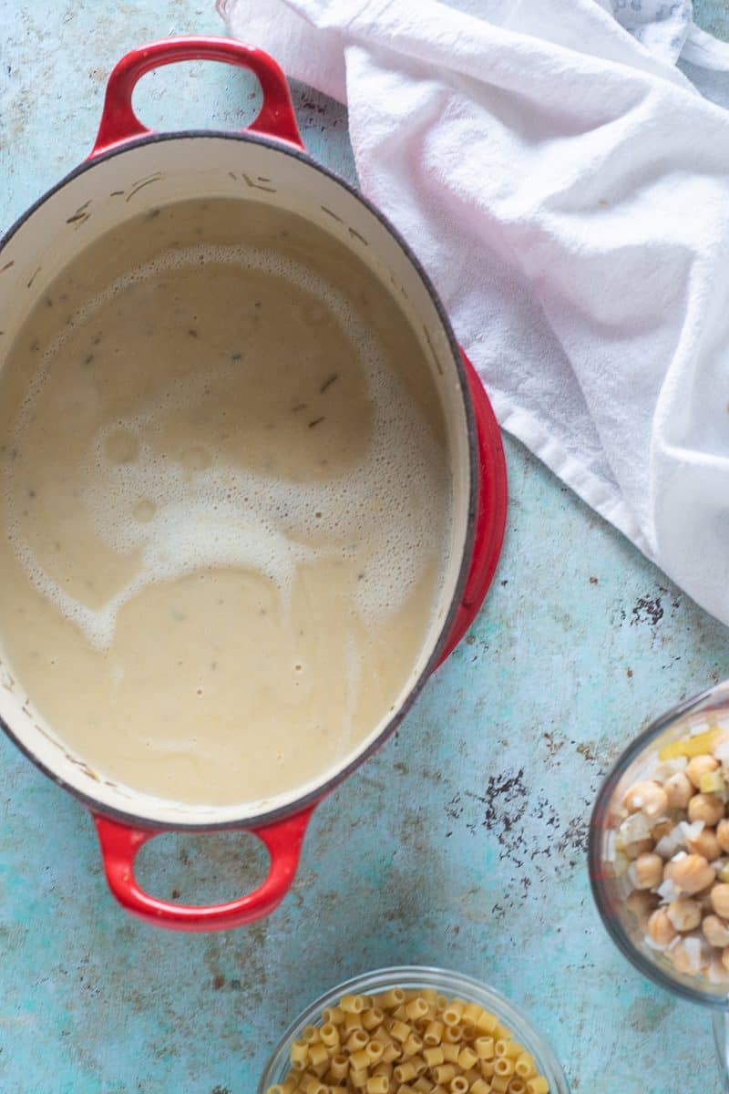 Blended chickpeas in a pot with ditalini and reserved chickpeas on the side