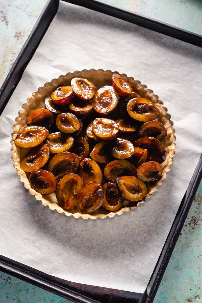 Plums arranged on a tart crust