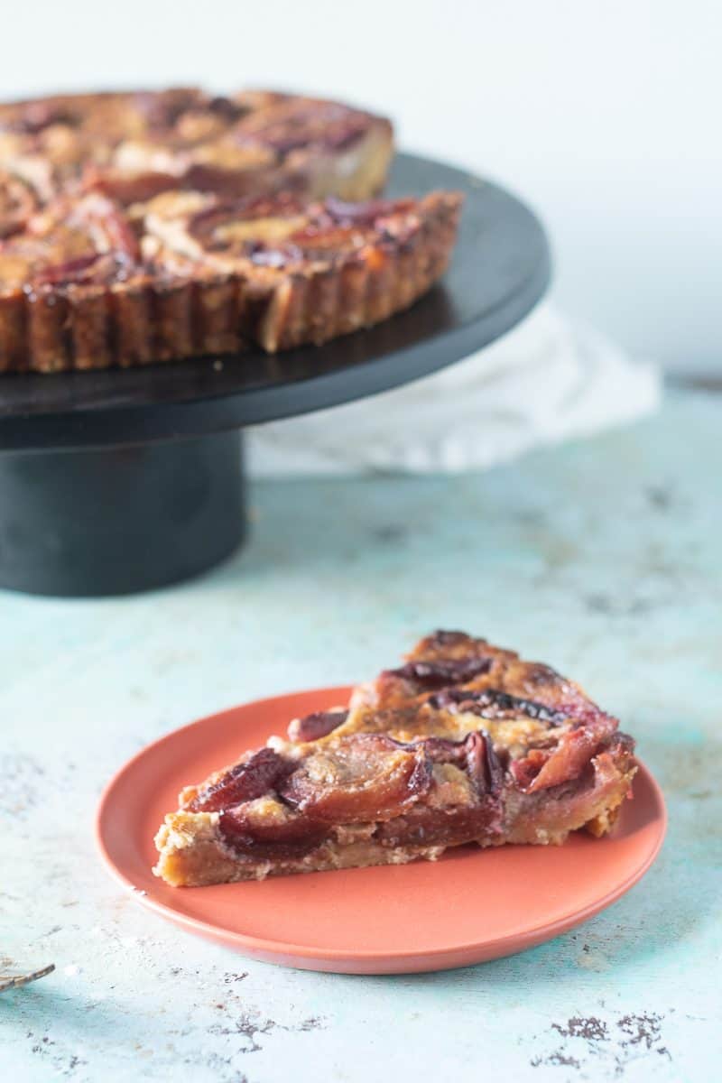 Plum Custard Tart with a slice removed