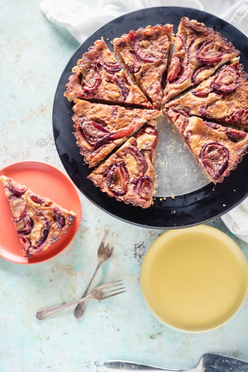 Plum Custard Tart with a slice removed