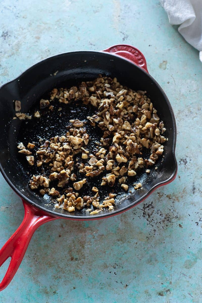 Walnuts, garlic, red pepper flakes, and olive oil in a skillet