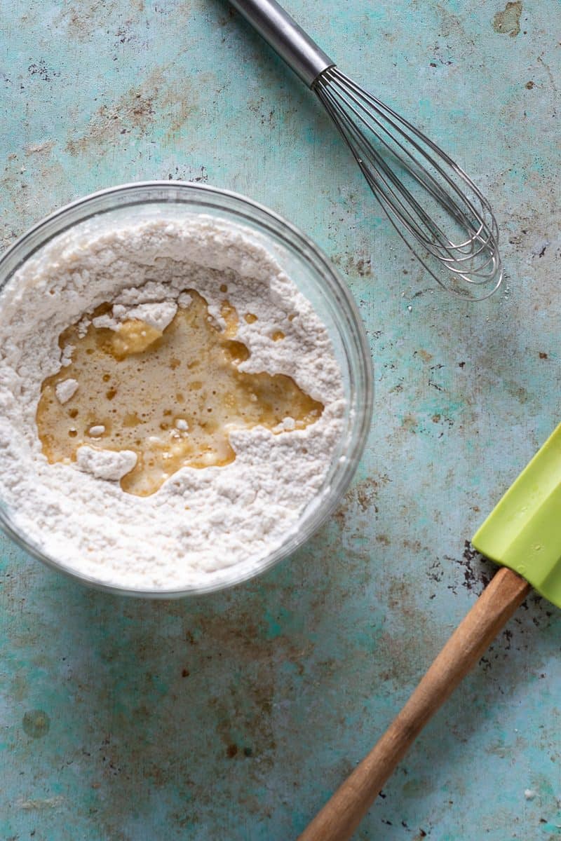 Melted butter and vanilla poured over flour mixture