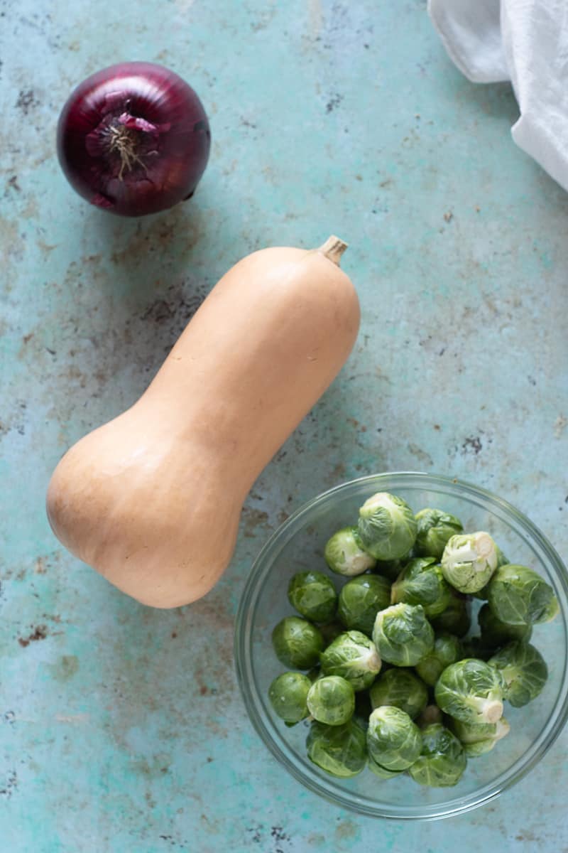 Red onion, butternut squash, Brussels sprouts in a bowl