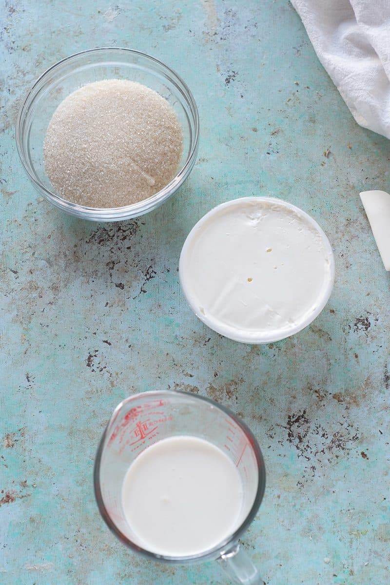Sugar, mascarpone, and heavy cream in bowls