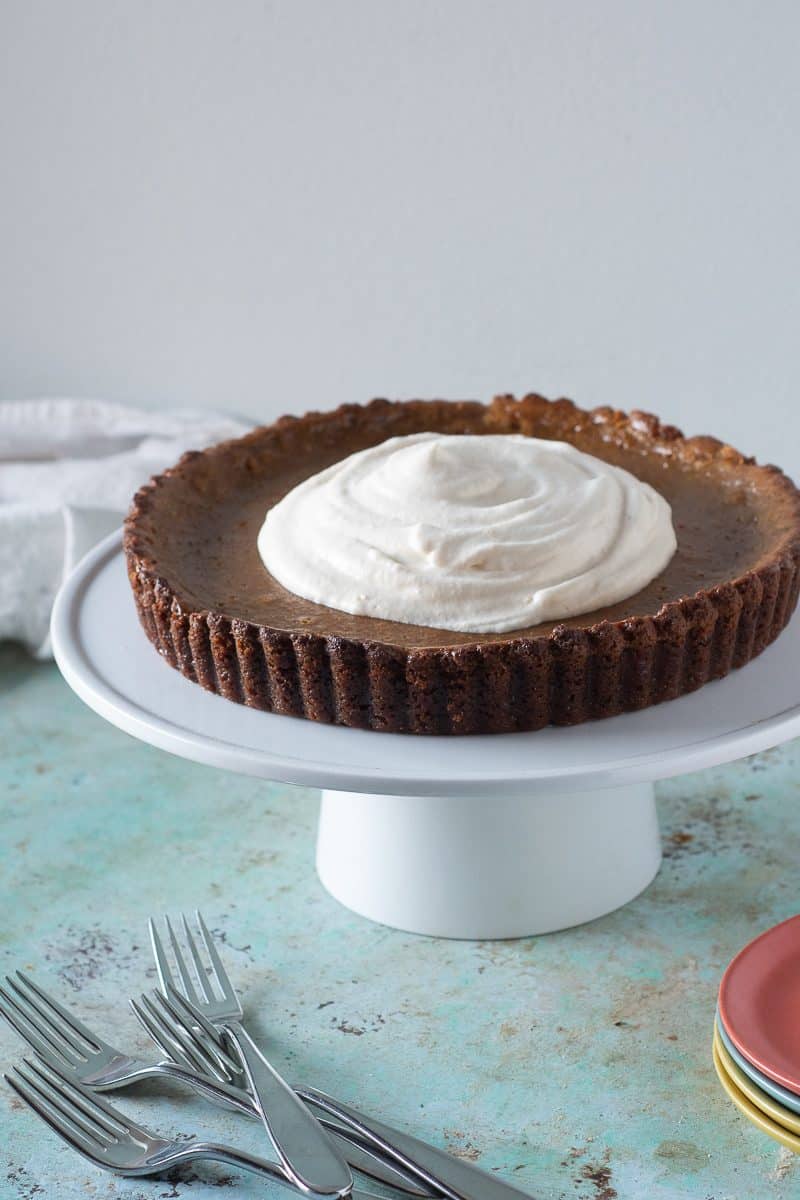 Caramel Pumpkin Tart with Gingersnap Crust, topped with whipped cream