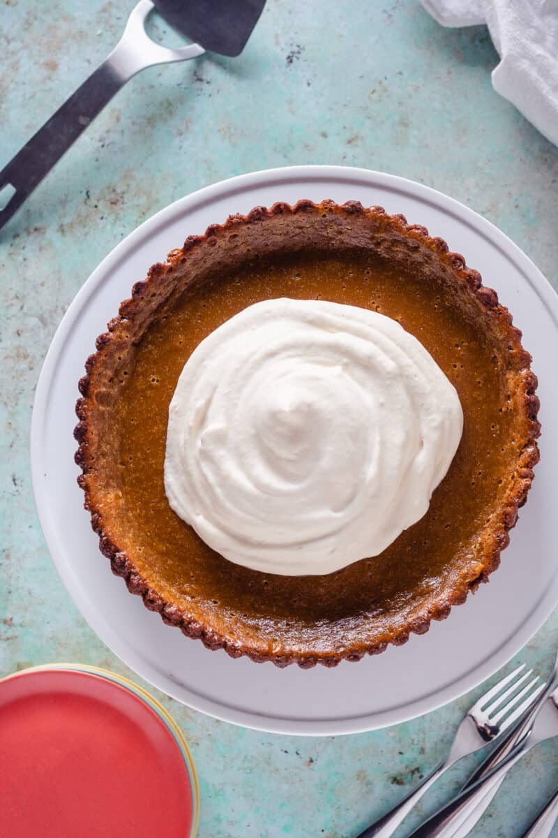 Caramel Pumpkin Tart on a white cake stand, overhead shot