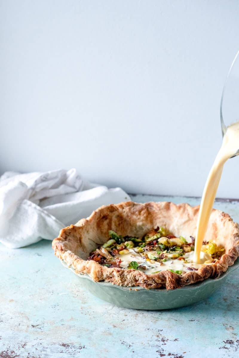 Adding custard mixture to pie shell