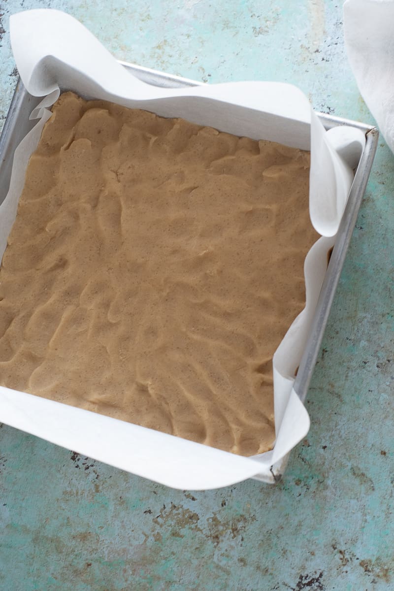 Brown sugar dough pressed into an even layer in baking pan