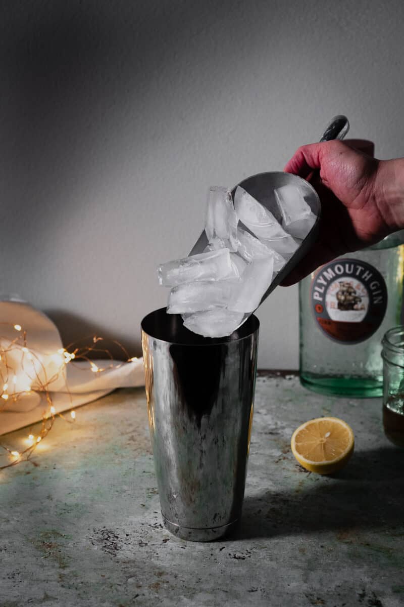 Scooping ice into a cocktail shaker