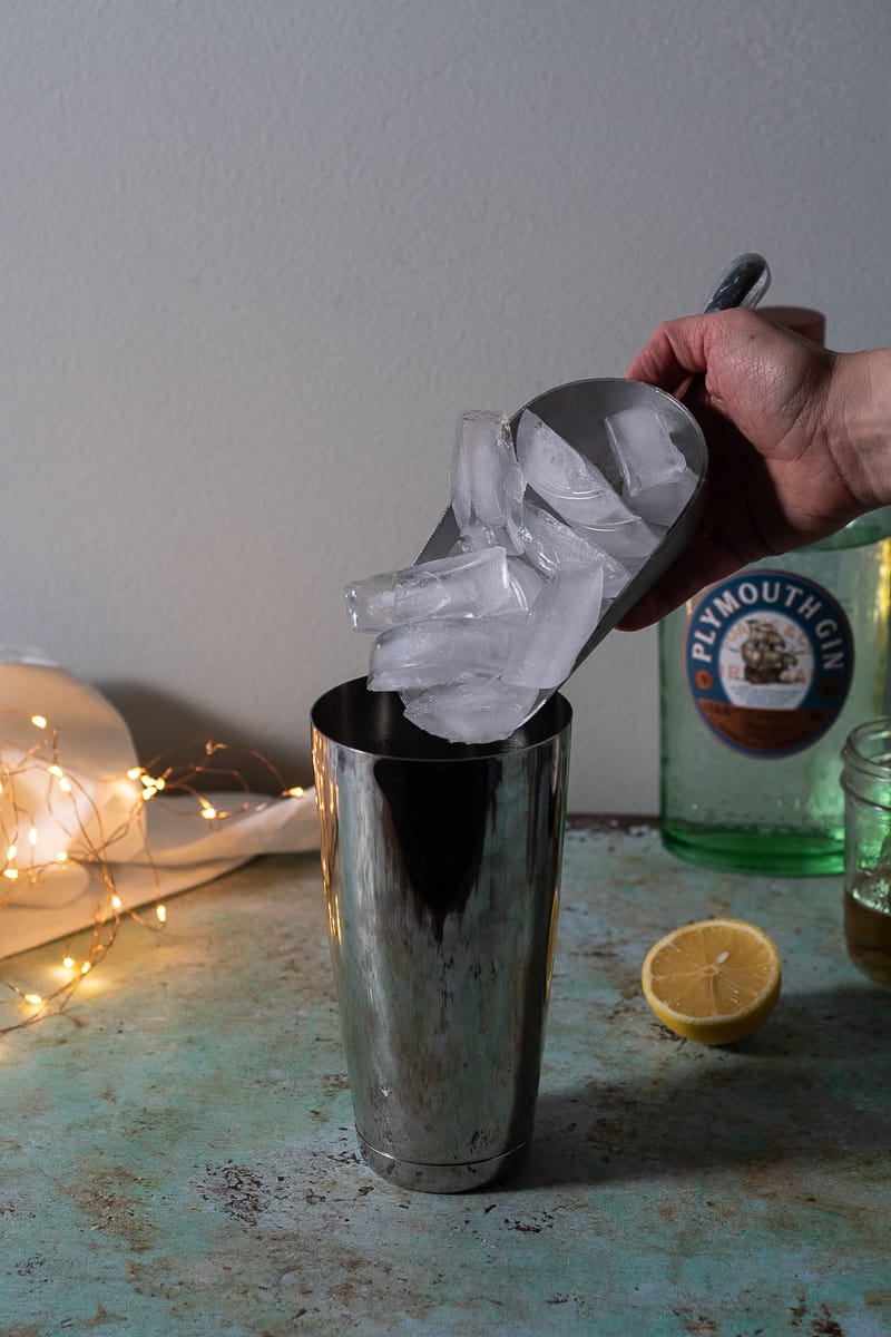 Adding ice to a cocktail shaker