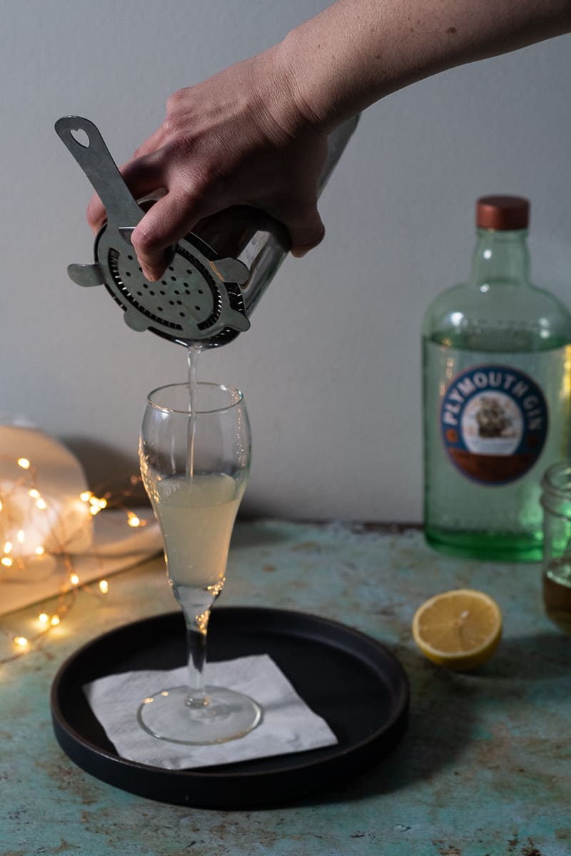 Straining a drink into a flute