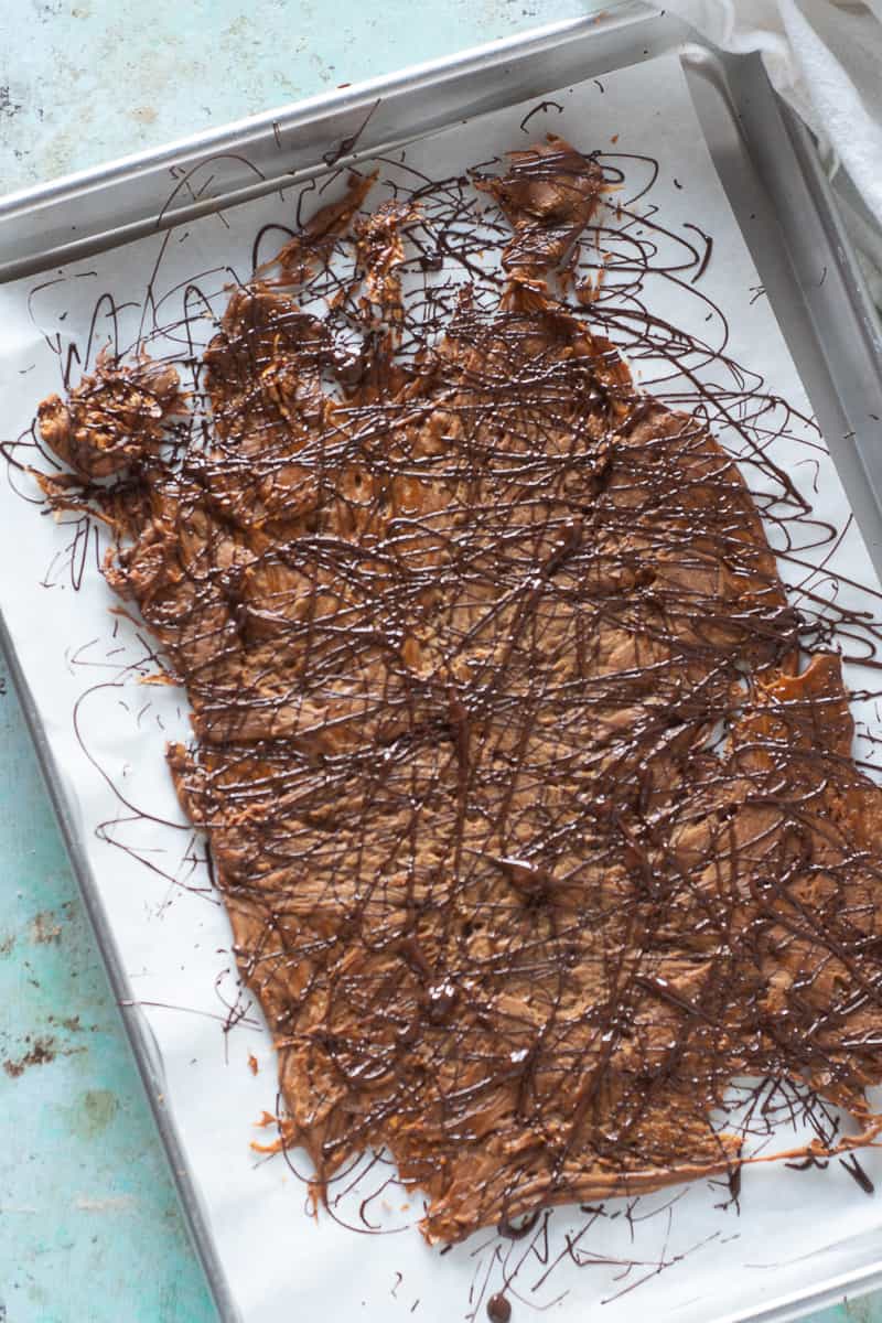 Chocolate drizzled over peanut butter brittle