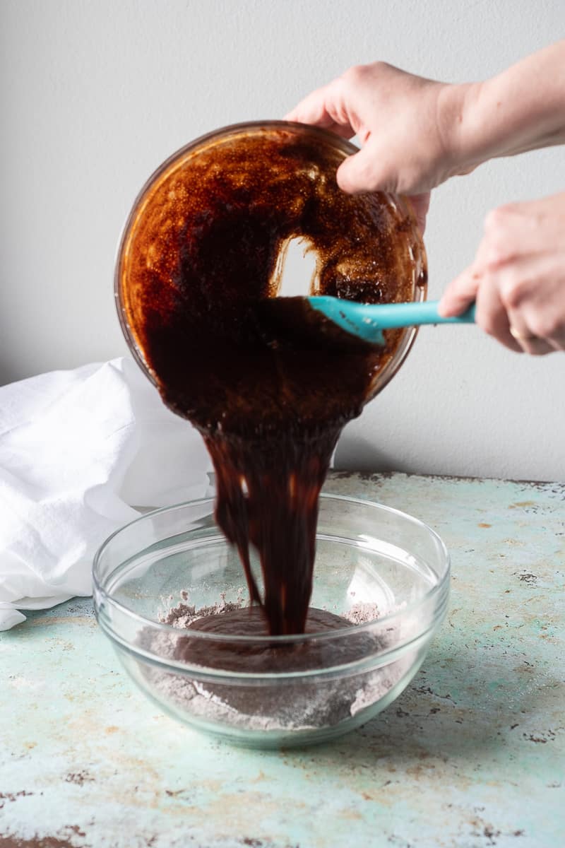 Adding the wet brownie ingredients to the dry ingredients