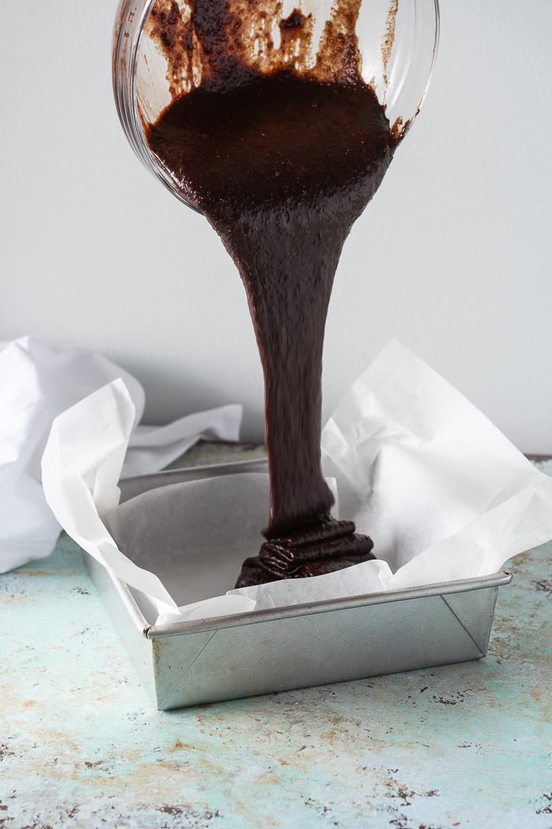 Brownie batter getting poured into the pan