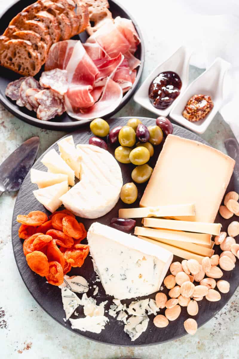 Cheese and charcuterie with olives, apricots, and almonds