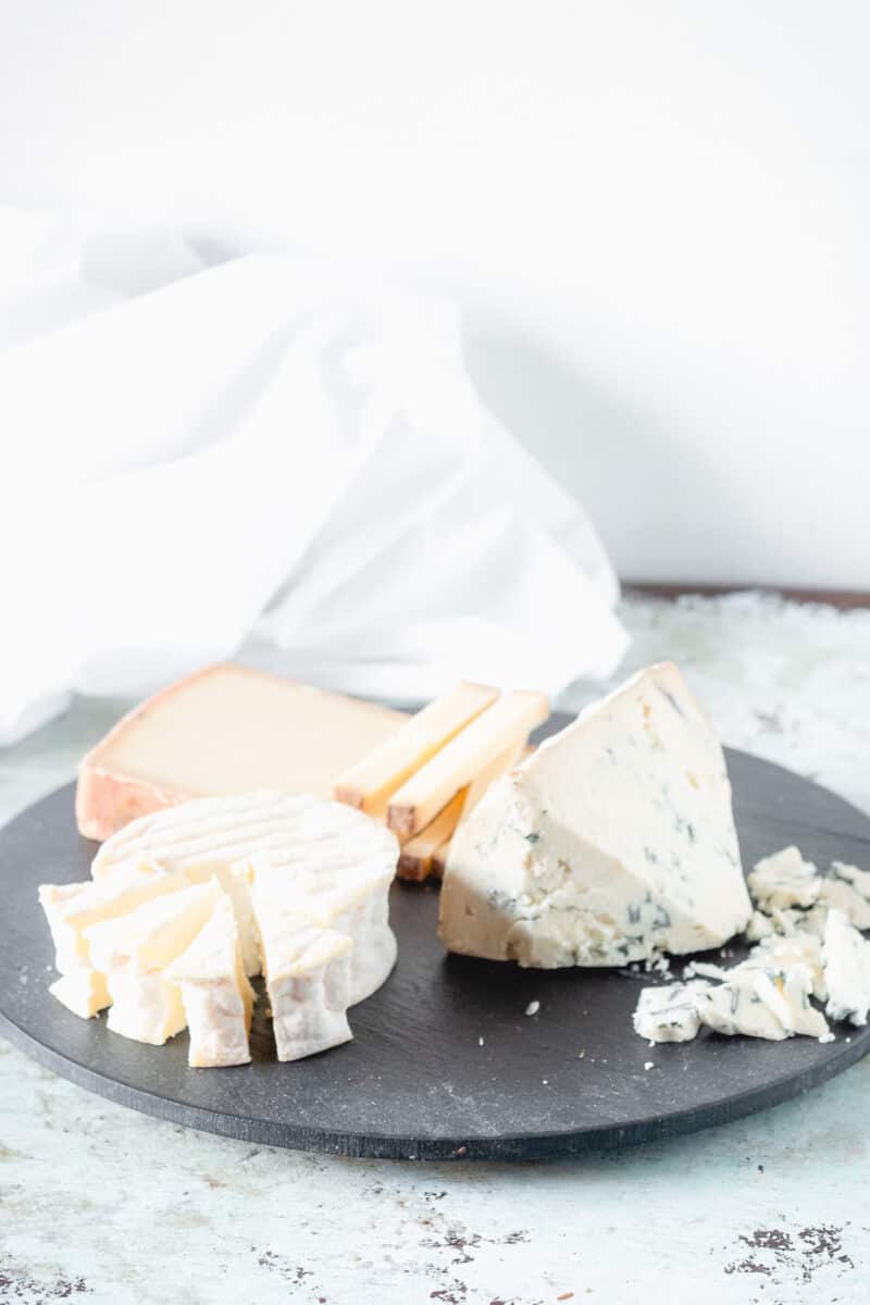 Sliced cheese on a slate board