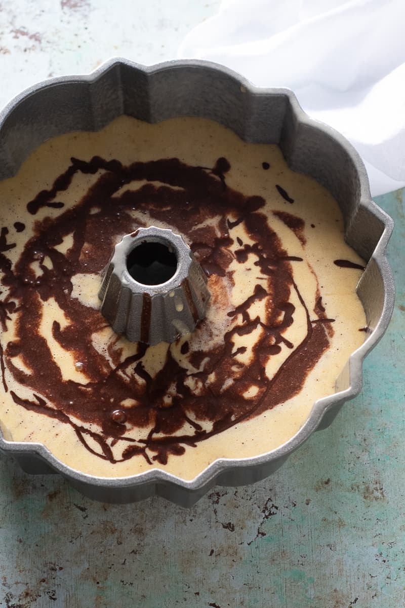Chocolate Orange Olive Oil cake batter swirled in a Bundt pan
