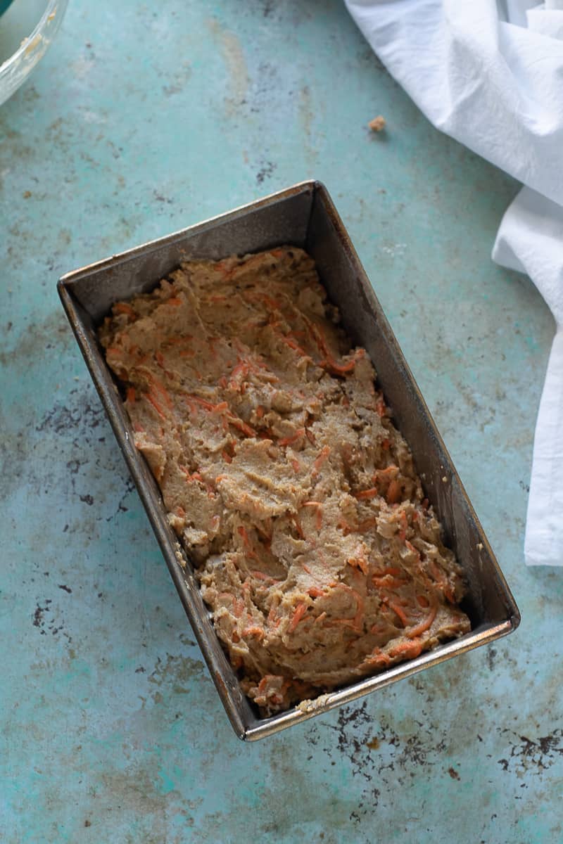 Carrot cake batter spread in a loaf pan