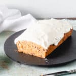 Carrot Loaf Cake with Cream Cheese Frosting, with slice removed to expose crumb
