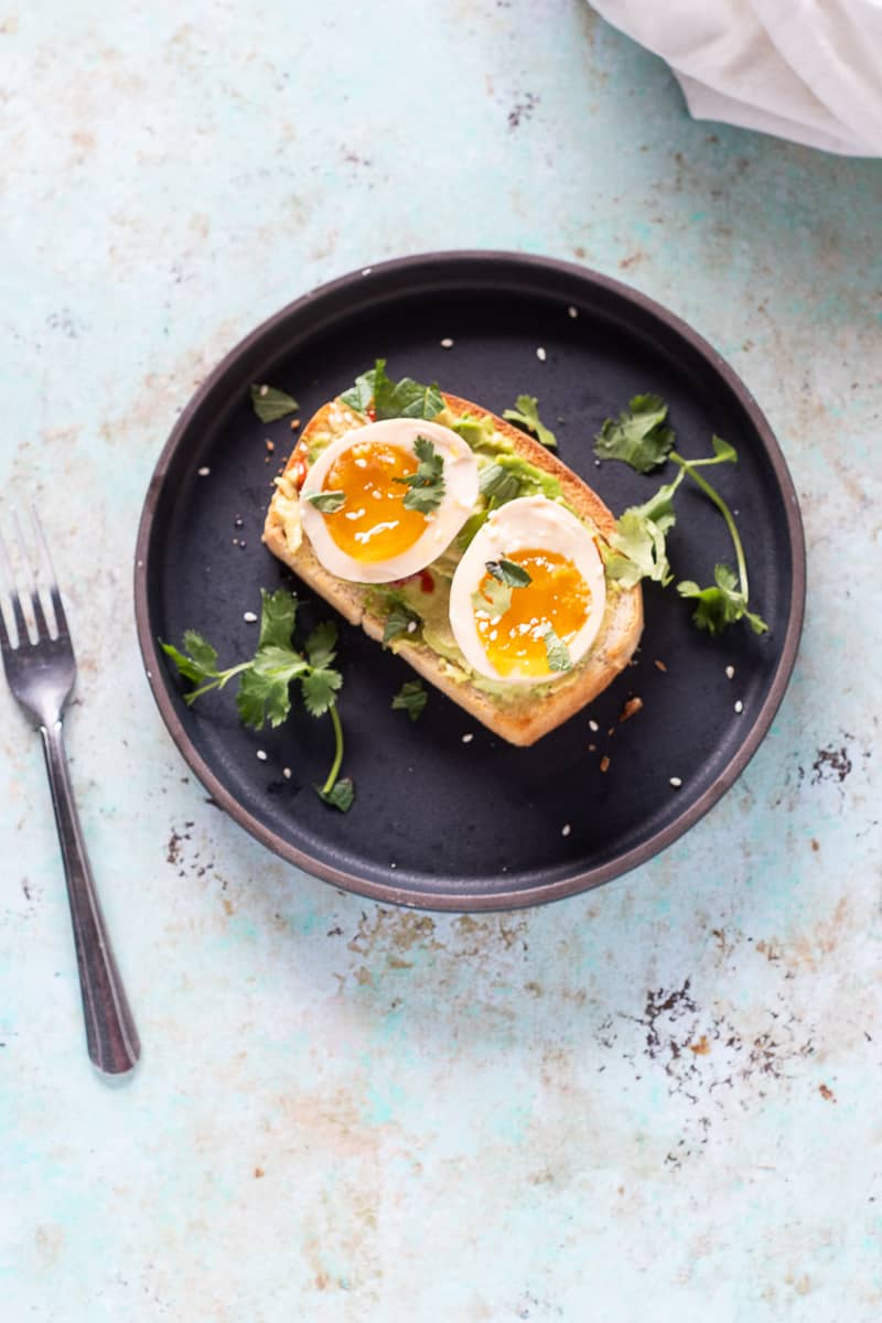 Ramen eggs on avocado toast overhead shot