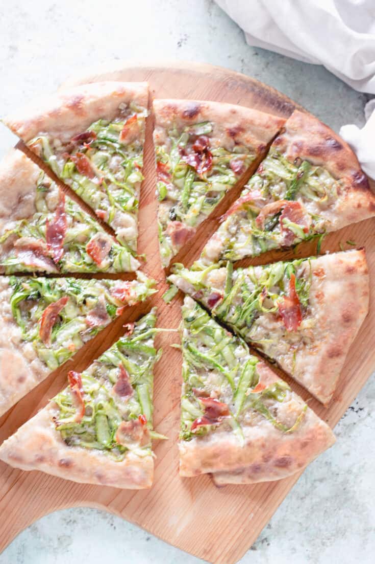 Asparagus Pizza, sliced on a peel