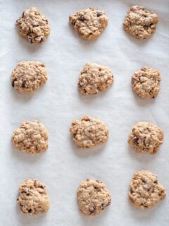 Soft and Chewy Oatmeal Raisin Cookies on parchment paper