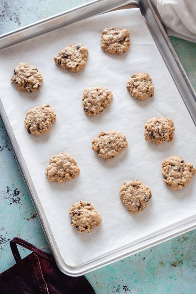 Soft and Chewy Oatmeal Raisin Cookies on a sheet pan